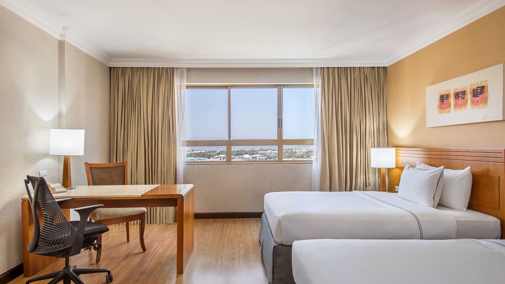 a room with two beds and a desk