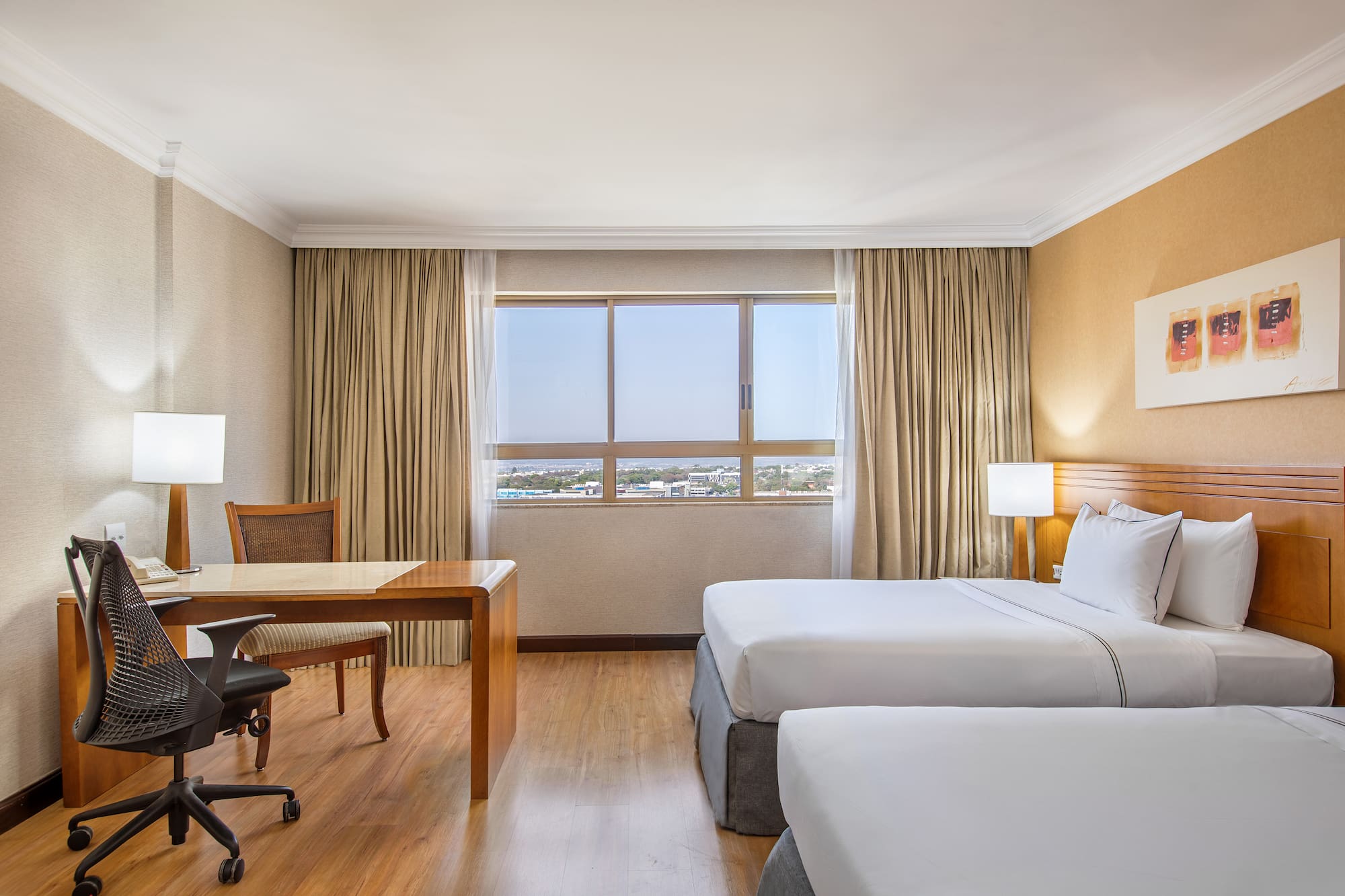 a room with two beds and a desk