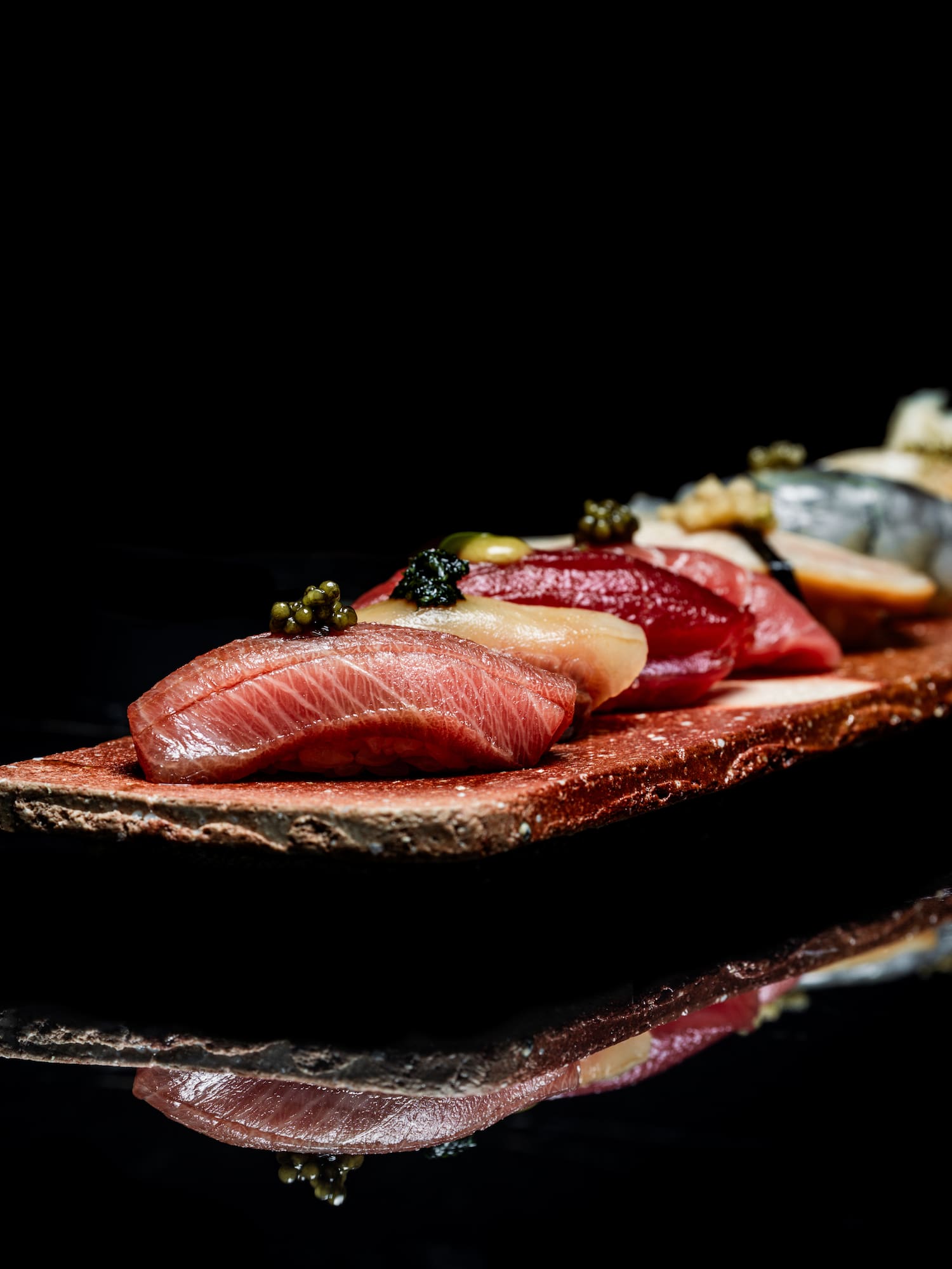 a plate of food on a black surface