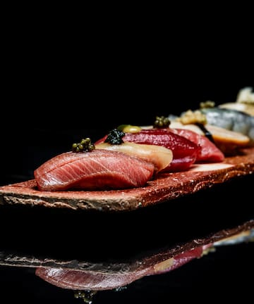 a plate of food on a black surface