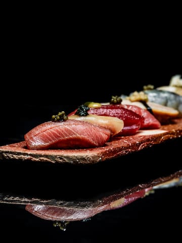 a plate of food on a black surface
