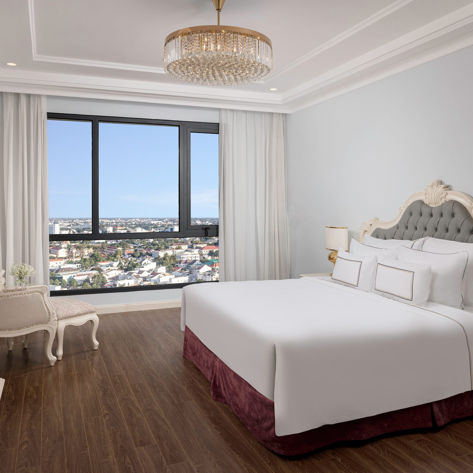 a bedroom with a large bed and a large window