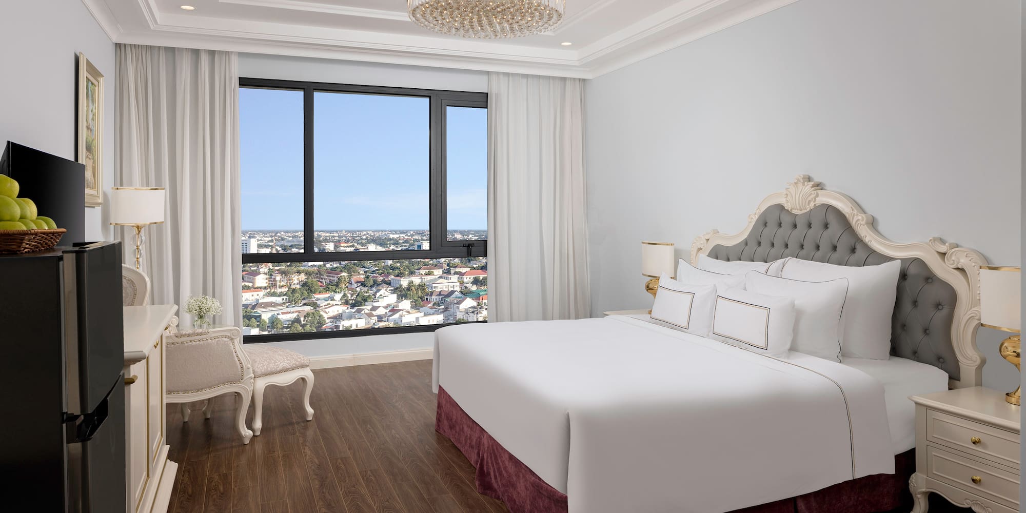 a bedroom with a large bed and a large window