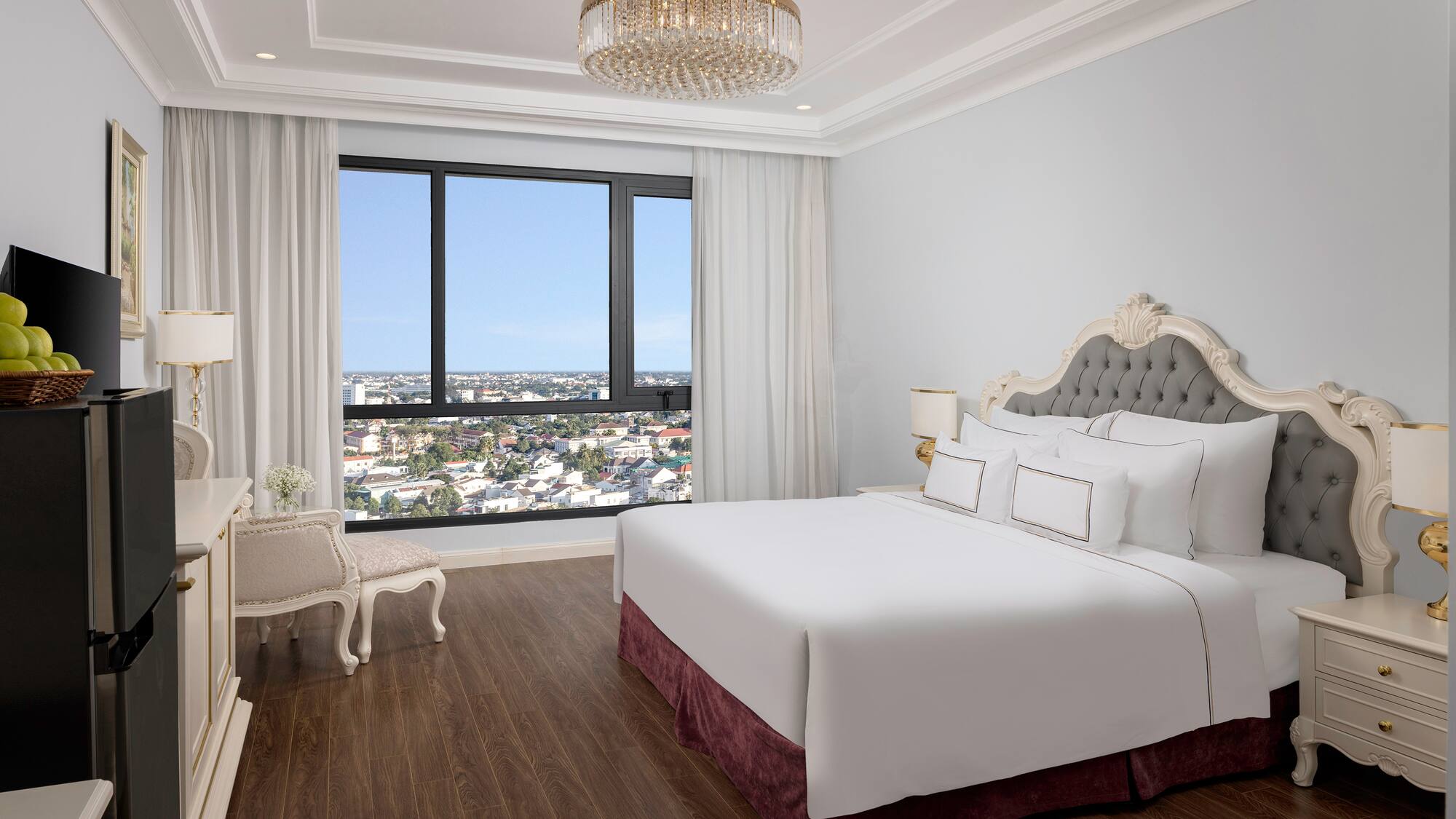 a bedroom with a large bed and a large window