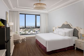 a bedroom with a large bed and a large window