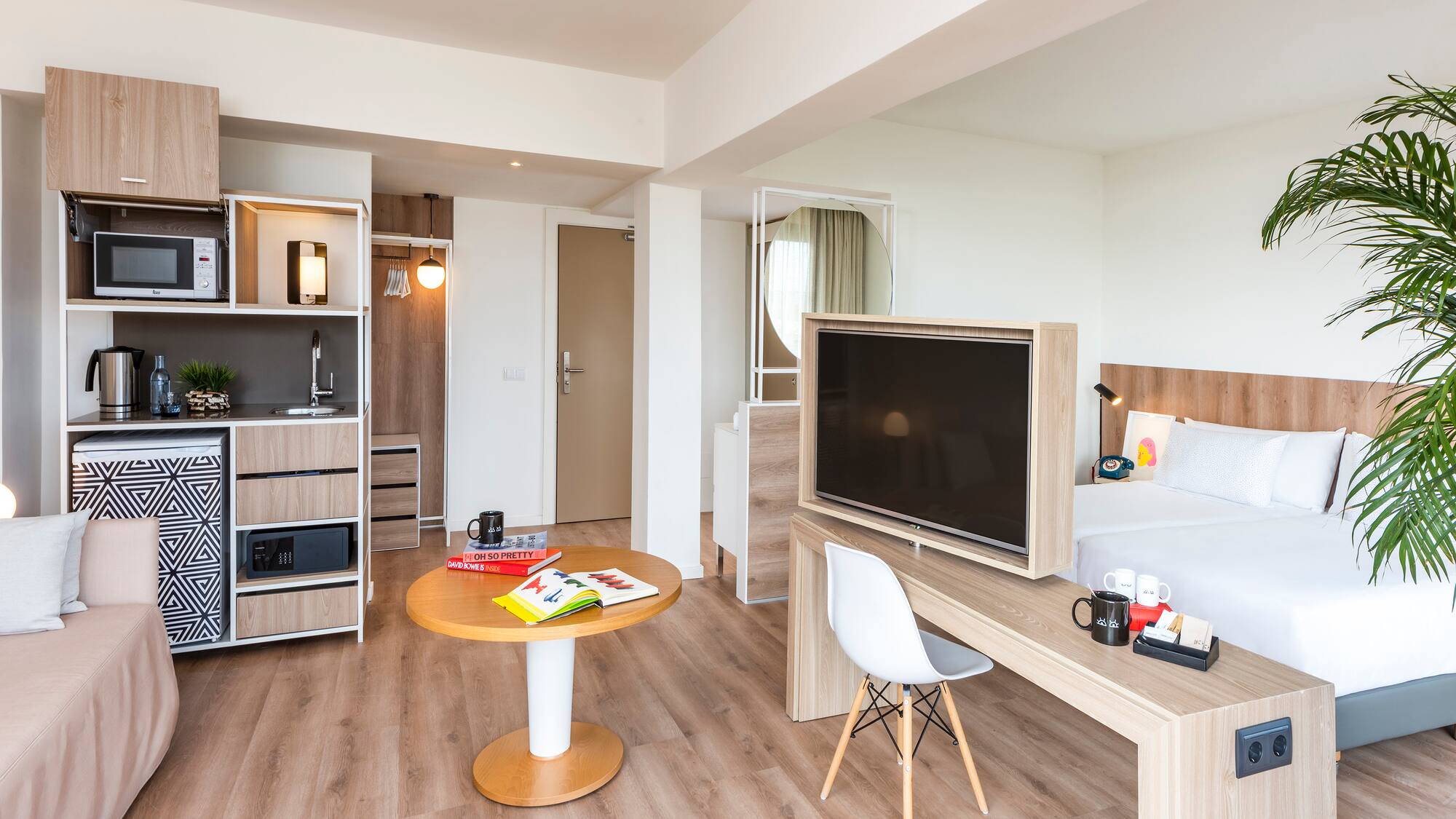 a room with a bed and a tv