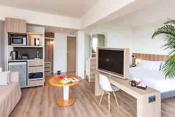 a room with a bed and a tv