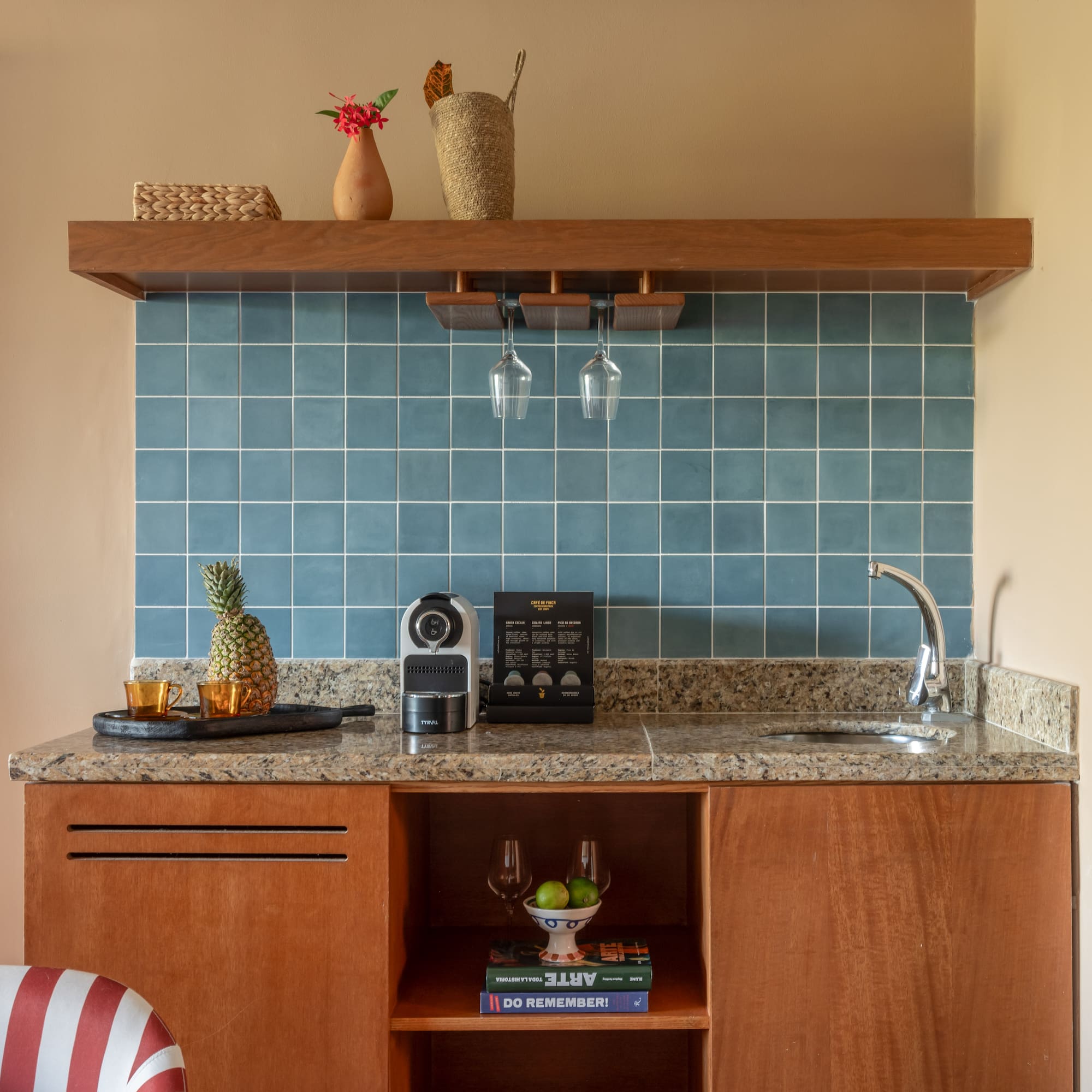 a kitchen counter with a sink and a shelf