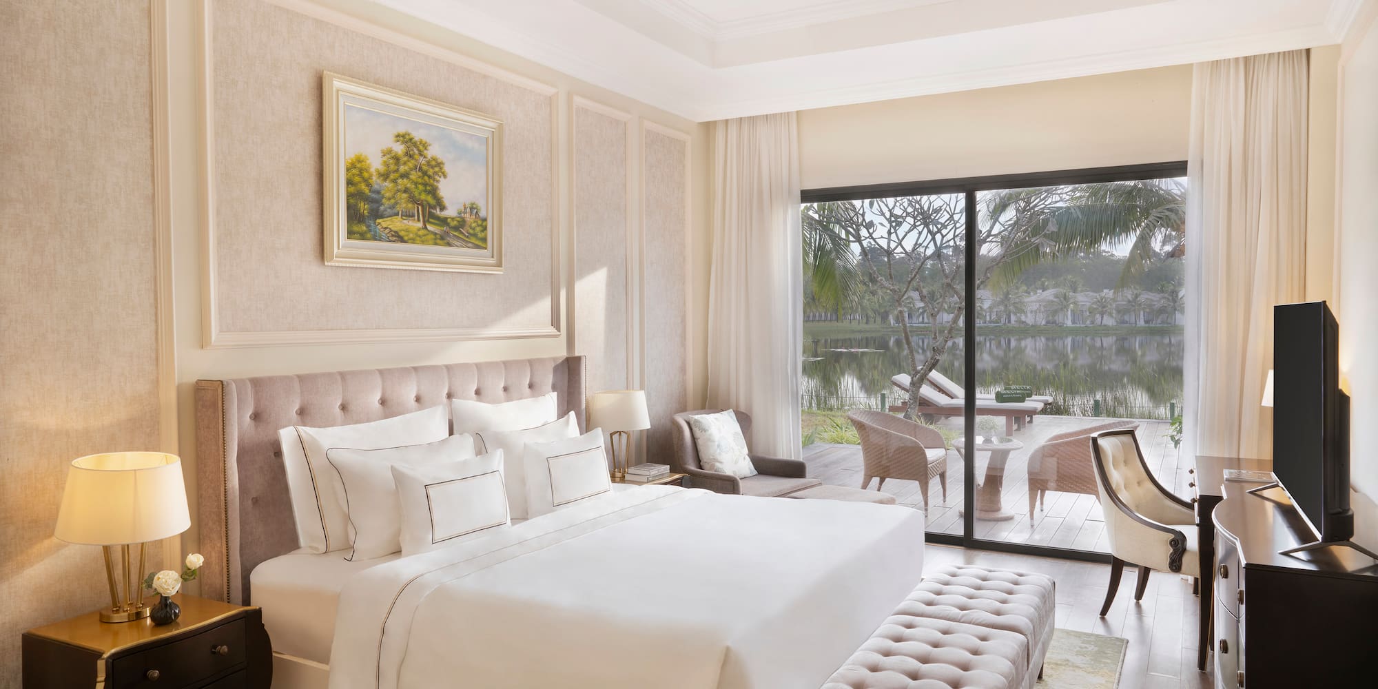 a bedroom with a large bed and a glass door