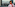 New York City skyline with One World Trade Center, blurred woman, red scarf.