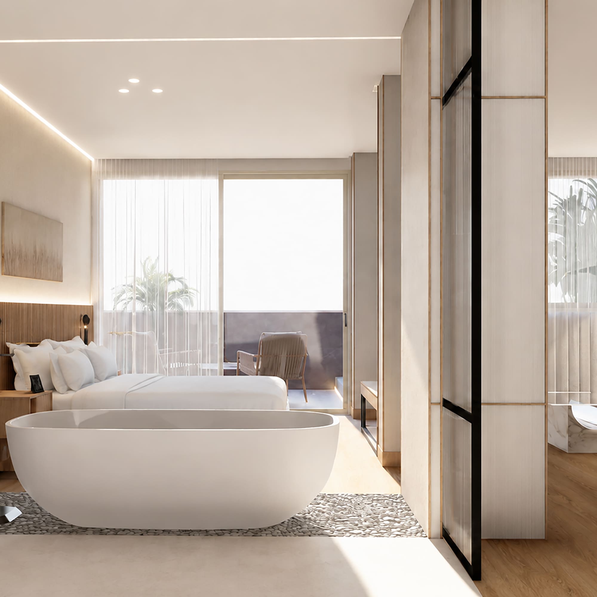 Modern luxury hotel suite with bedroom, freestanding tub, and balcony living area.