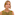 Professional headshot: blonde woman in olive green top with subtle smile.