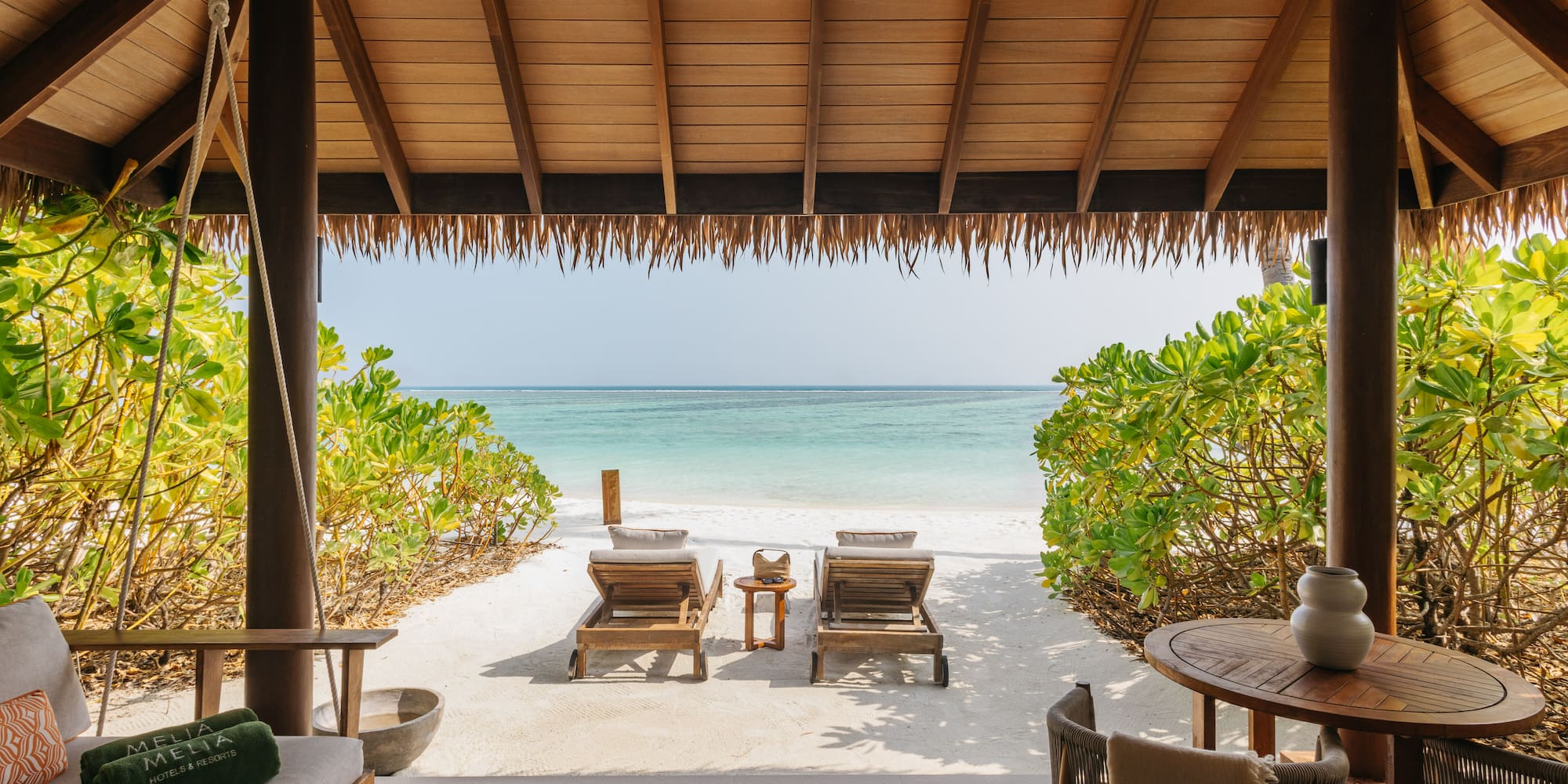 a beach with chairs and a table on a beach