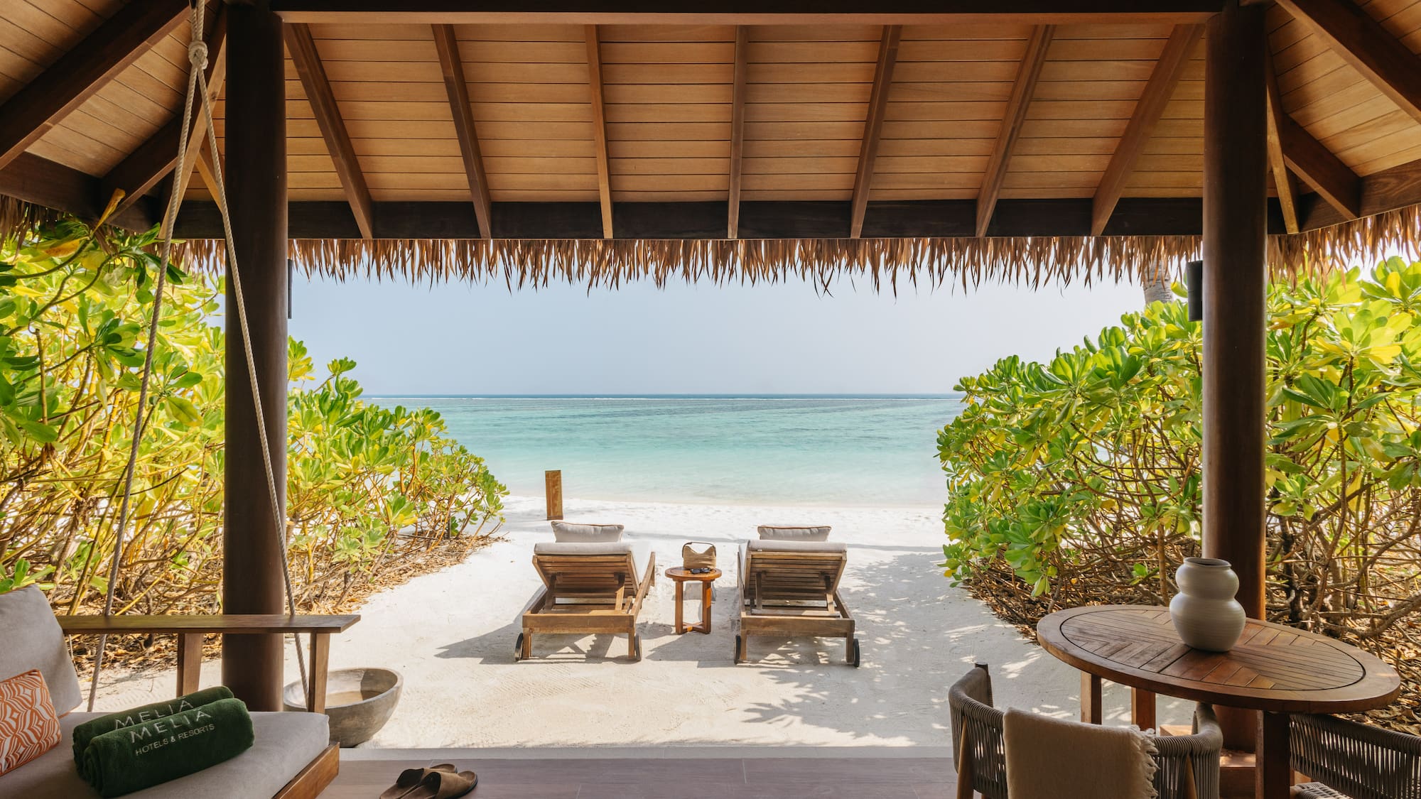 a beach with chairs and a table on a beach