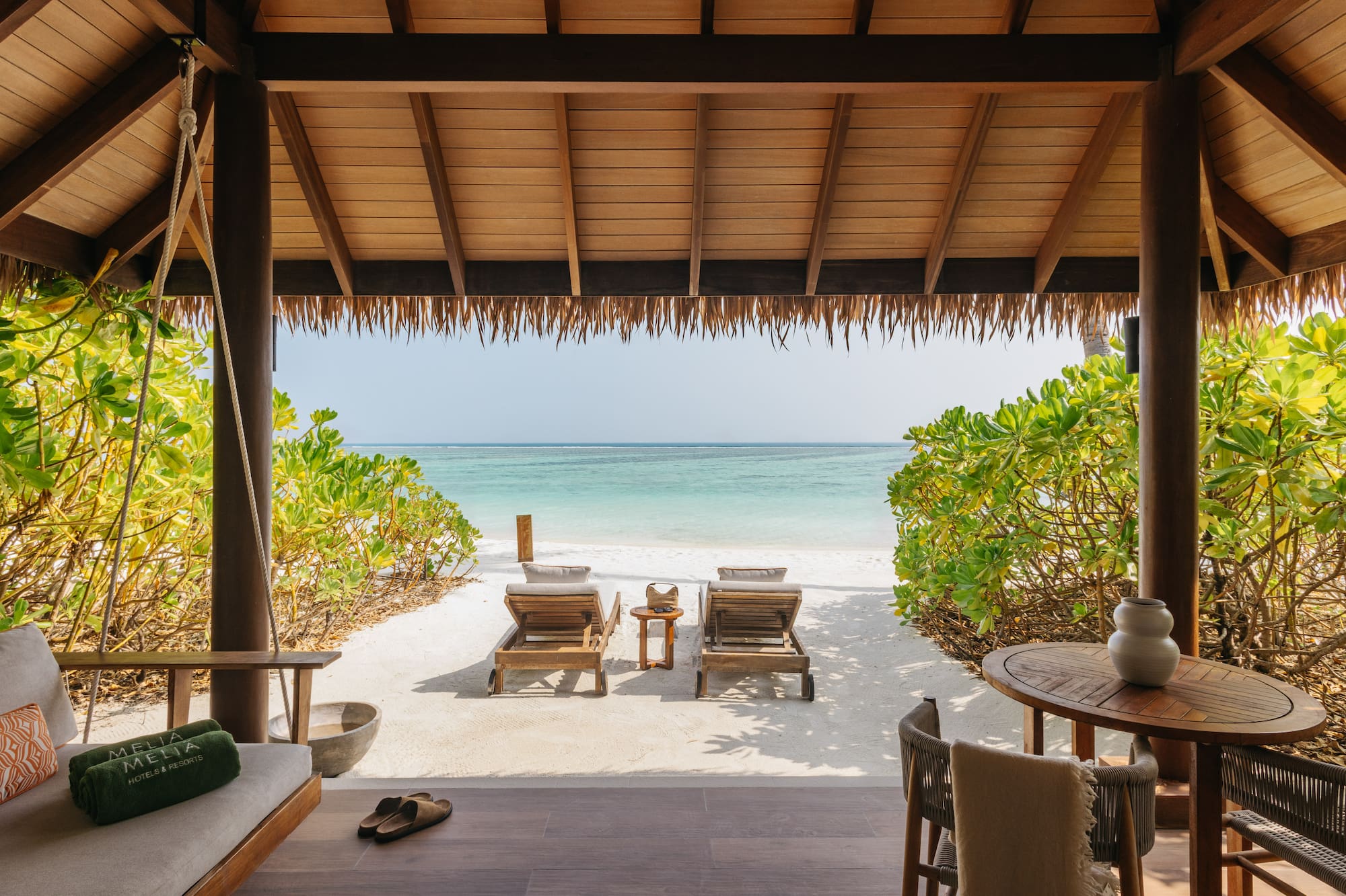a beach with chairs and a table on a beach