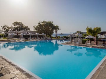 a swimming pool with umbrellas and chairs