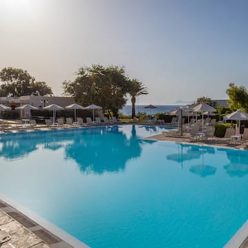 a swimming pool with umbrellas and chairs