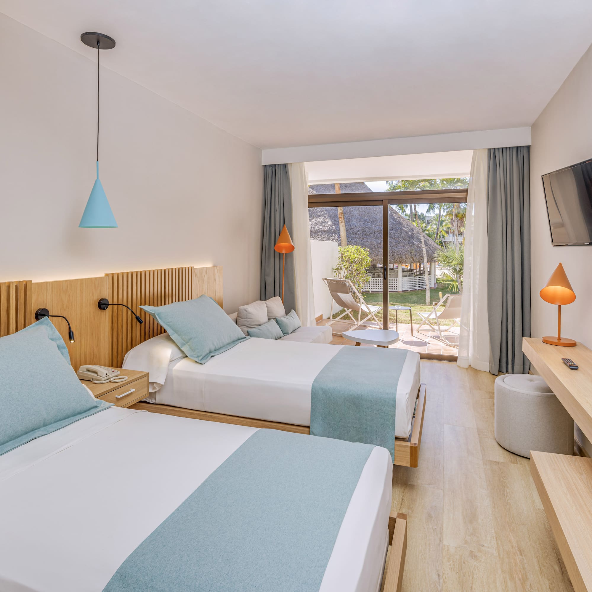 a room with two beds and a television