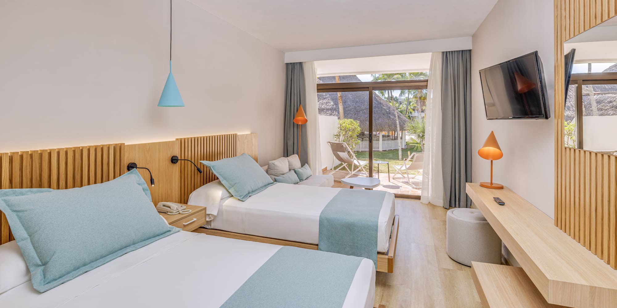 a room with two beds and a television