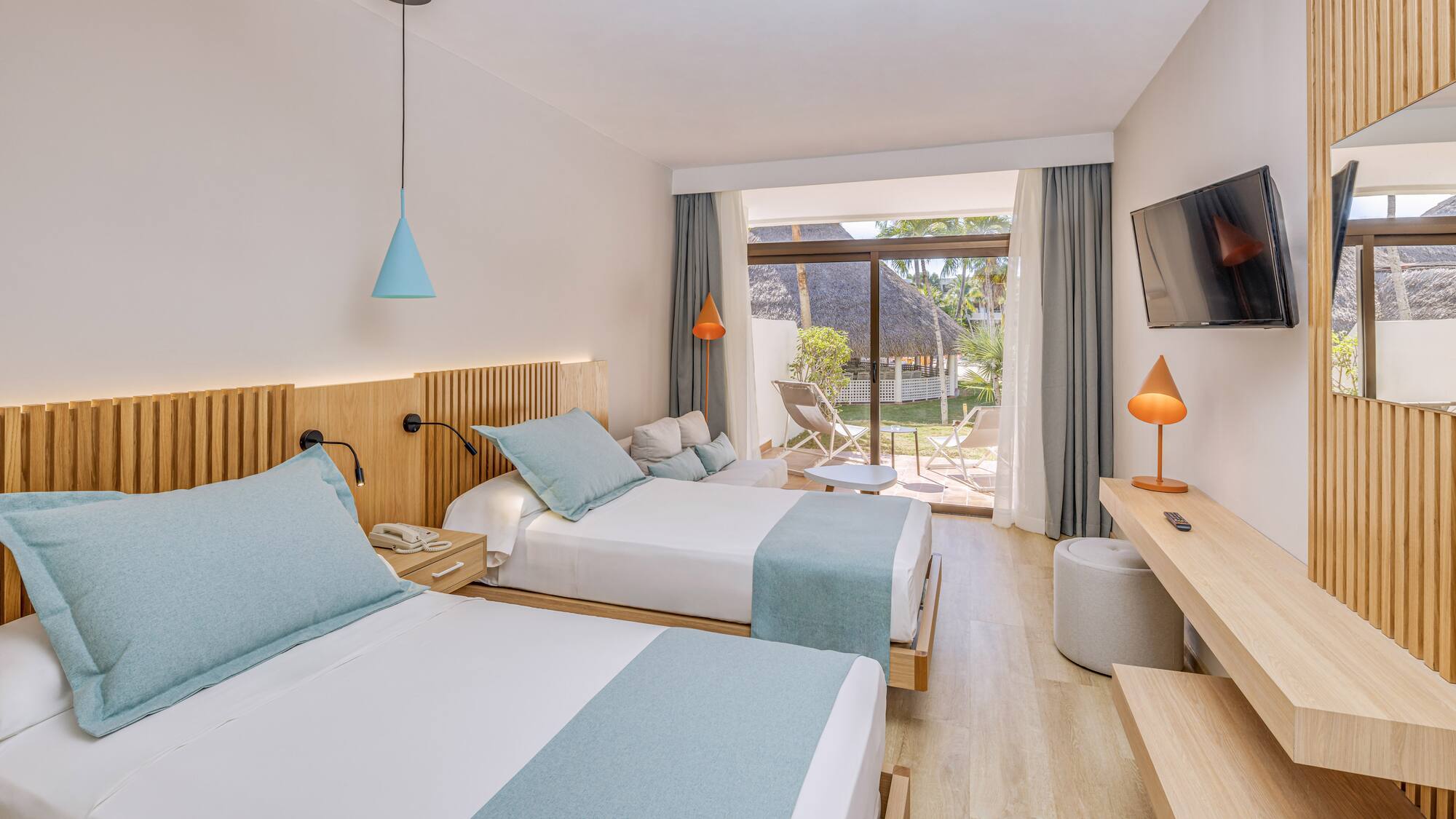 a room with two beds and a television