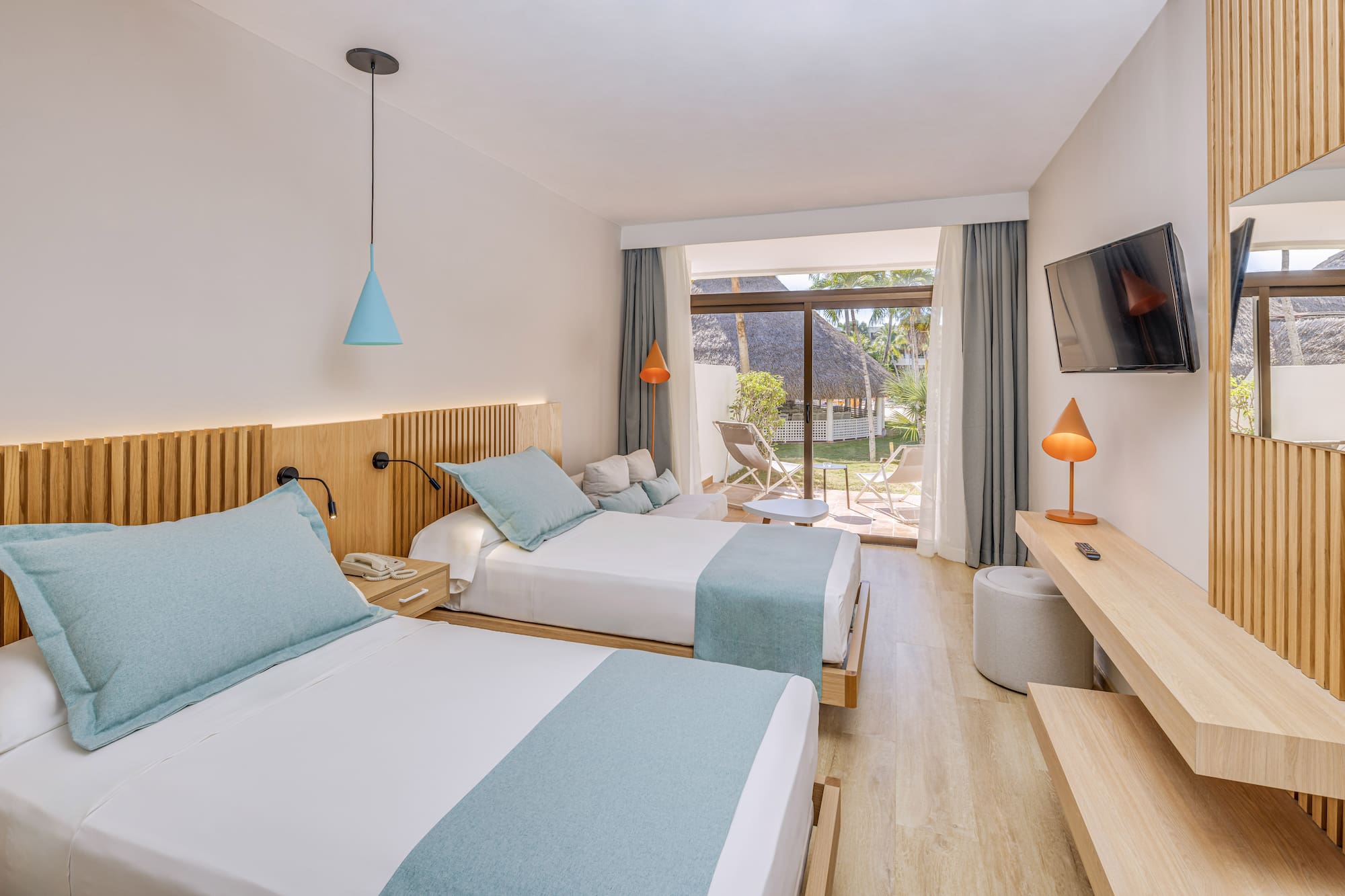 a room with two beds and a television