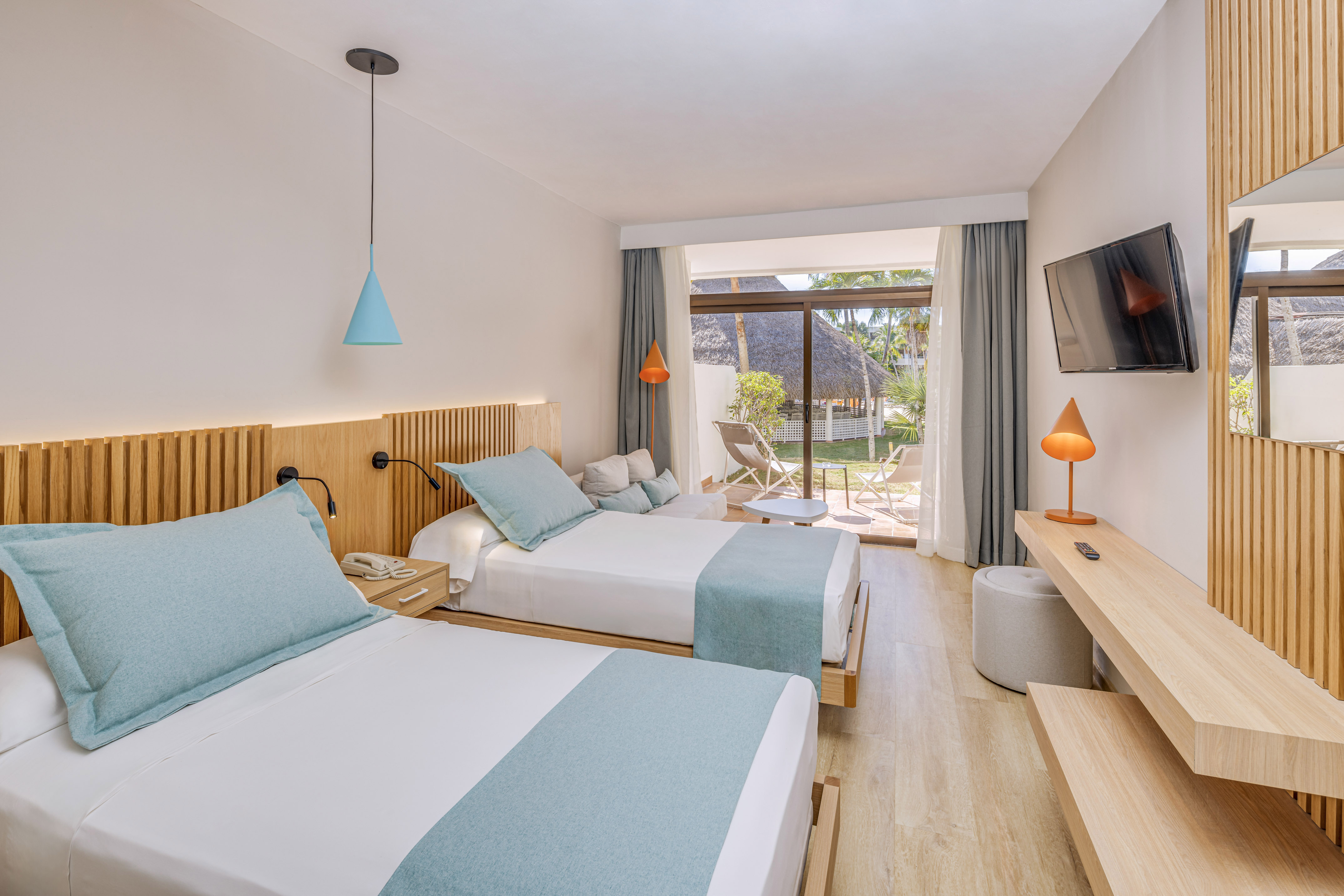 a room with two beds and a television