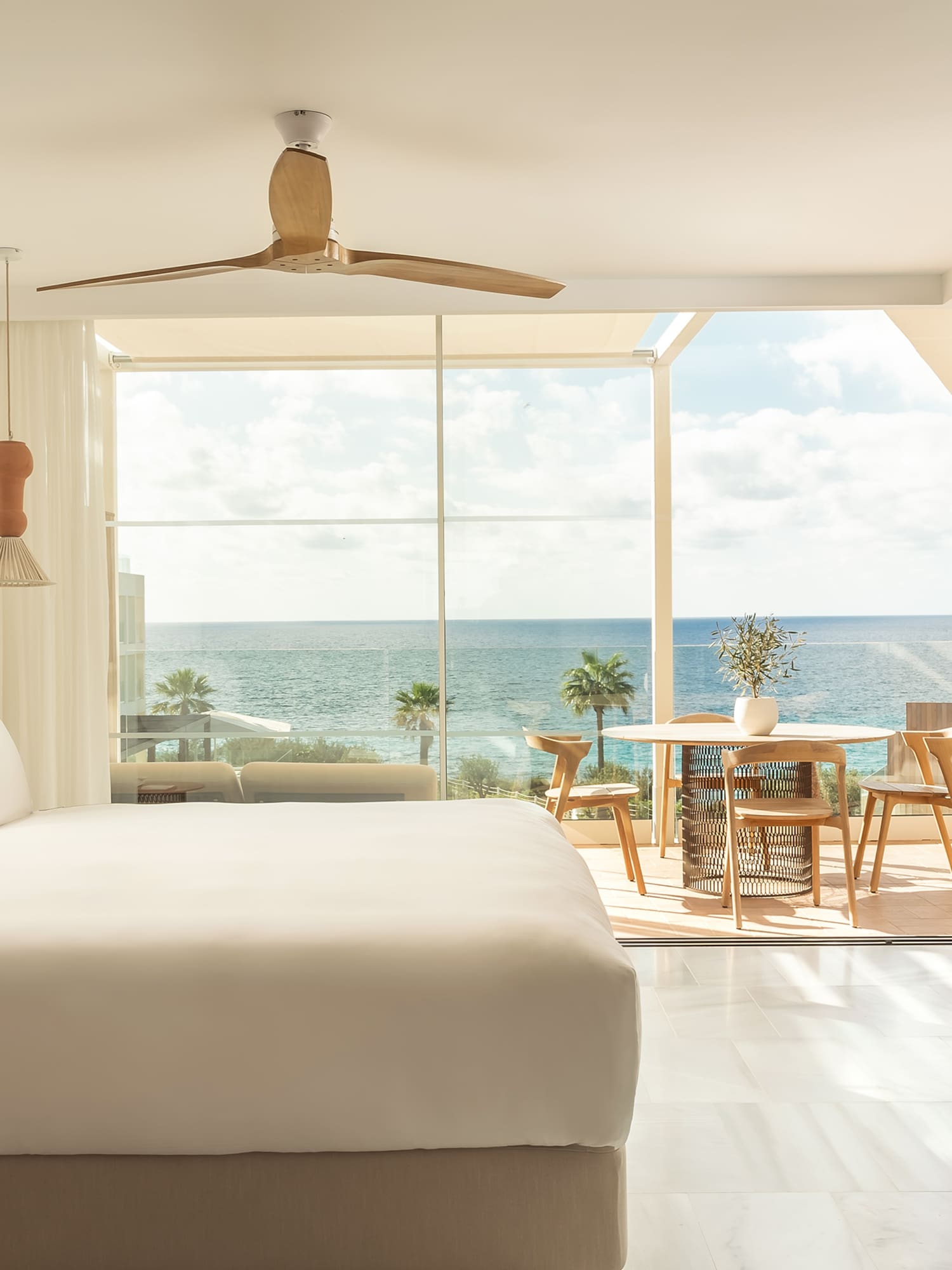 a room with a large window and a large bed