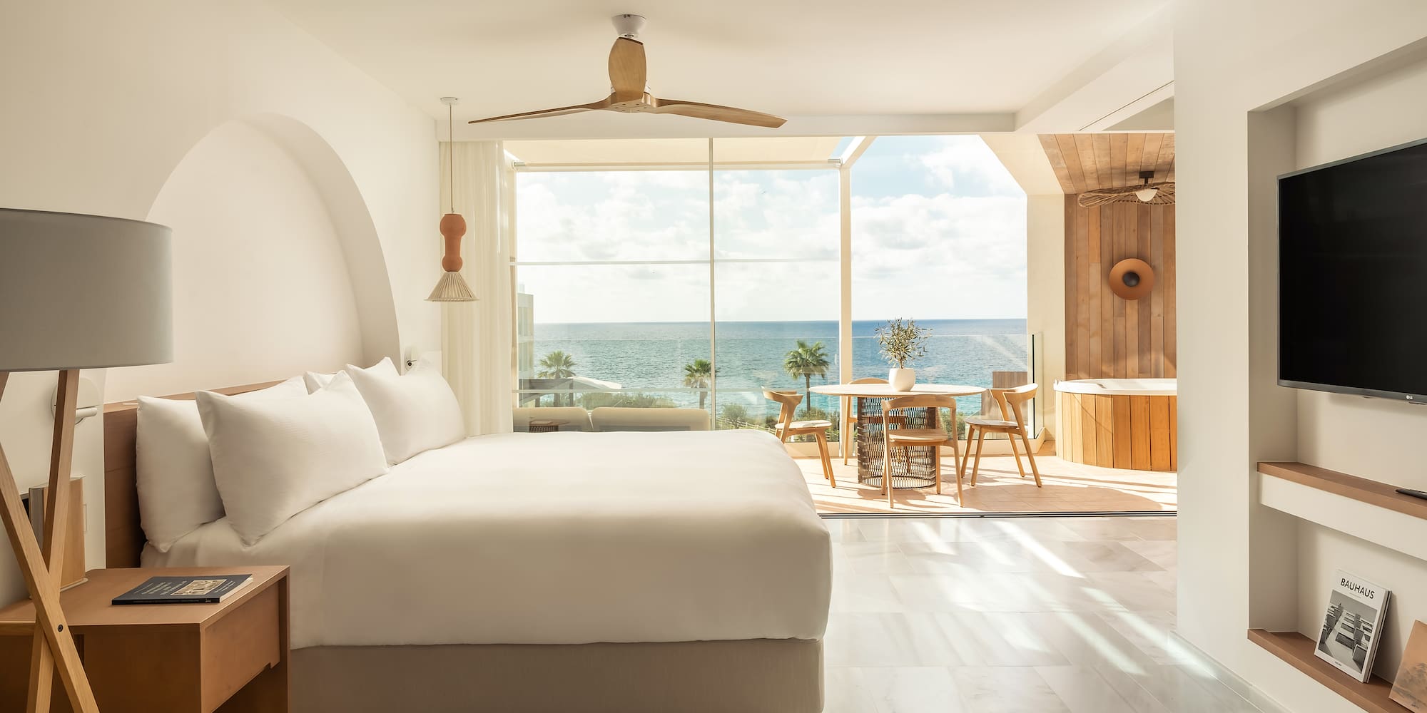 a room with a large window and a large bed