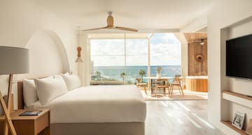 a room with a large window and a large bed