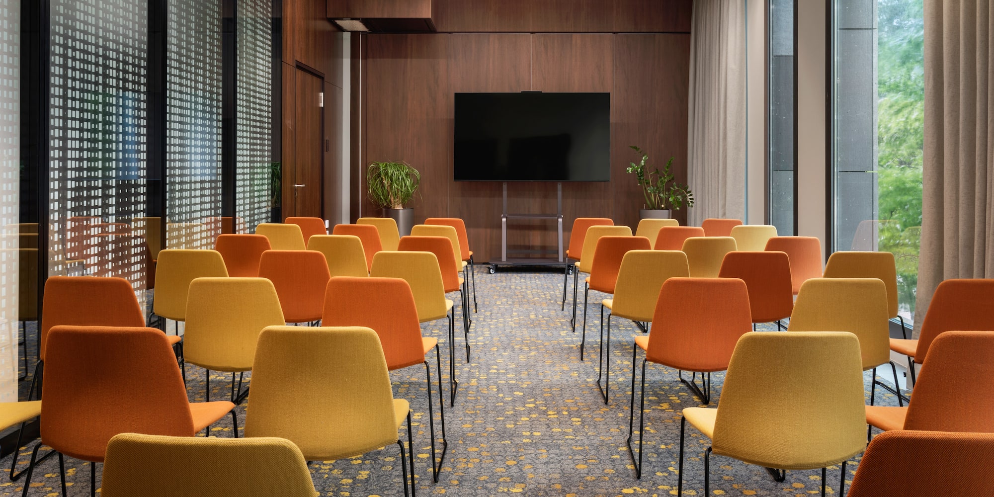 a room with many chairs and a screen