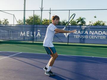 a man holding a tennis racket