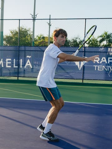 a man holding a tennis racket