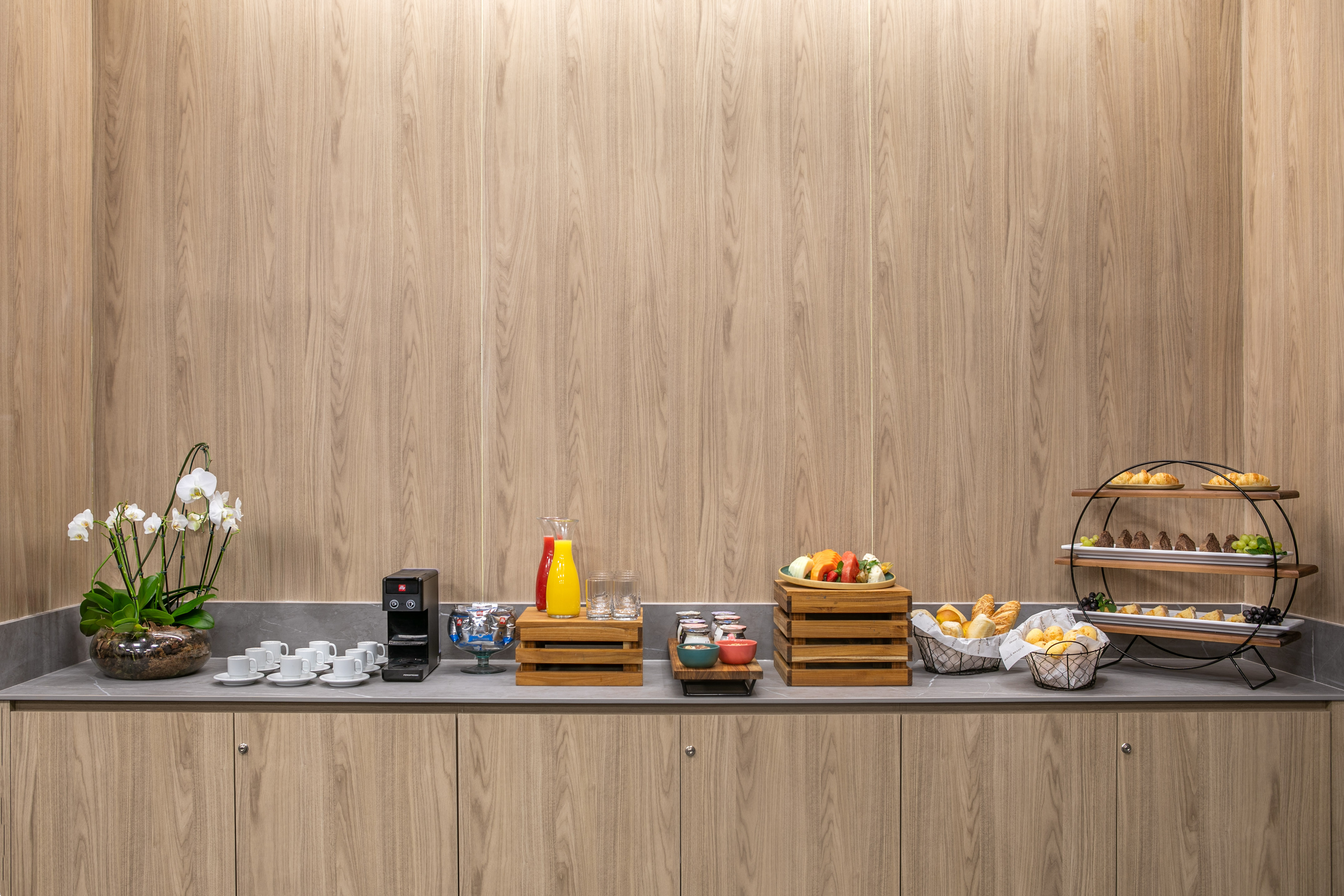 Continental breakfast buffet with coffee, juice, fresh fruit, and assorted pastries.