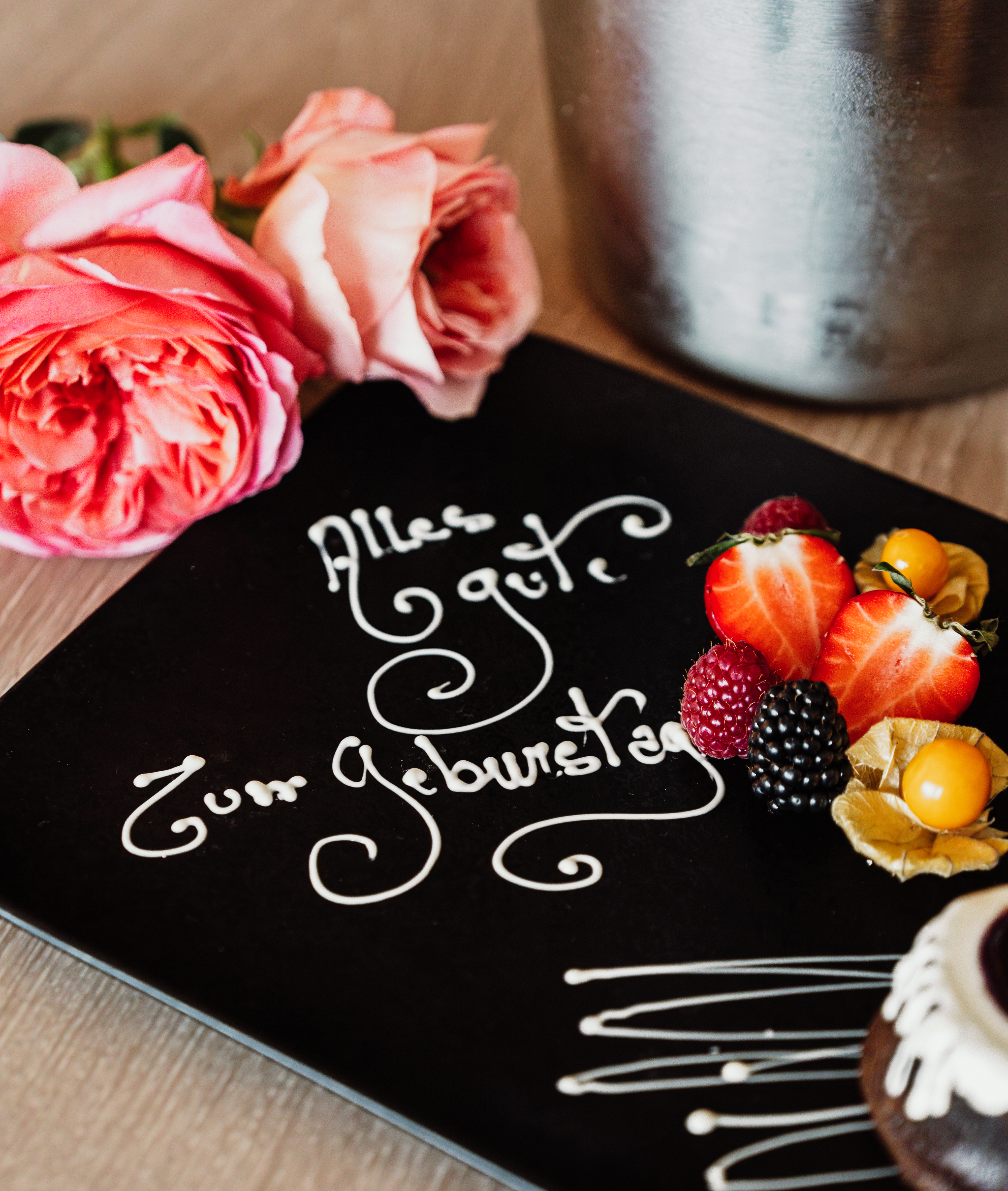 a plate with fruit and flowers on it