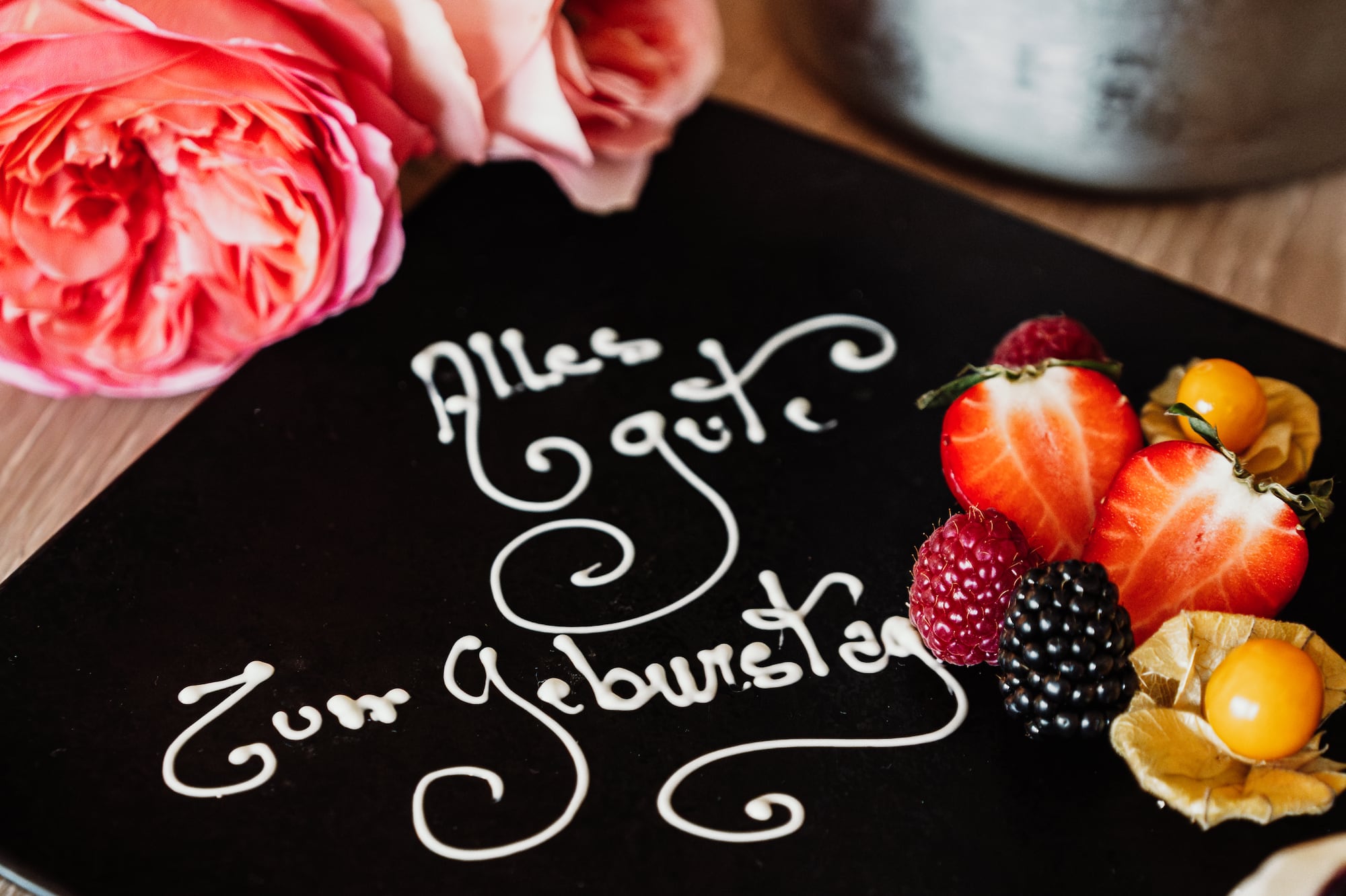 a plate with fruit and flowers on it