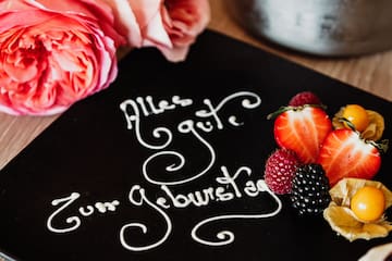 a plate with fruit and flowers on it