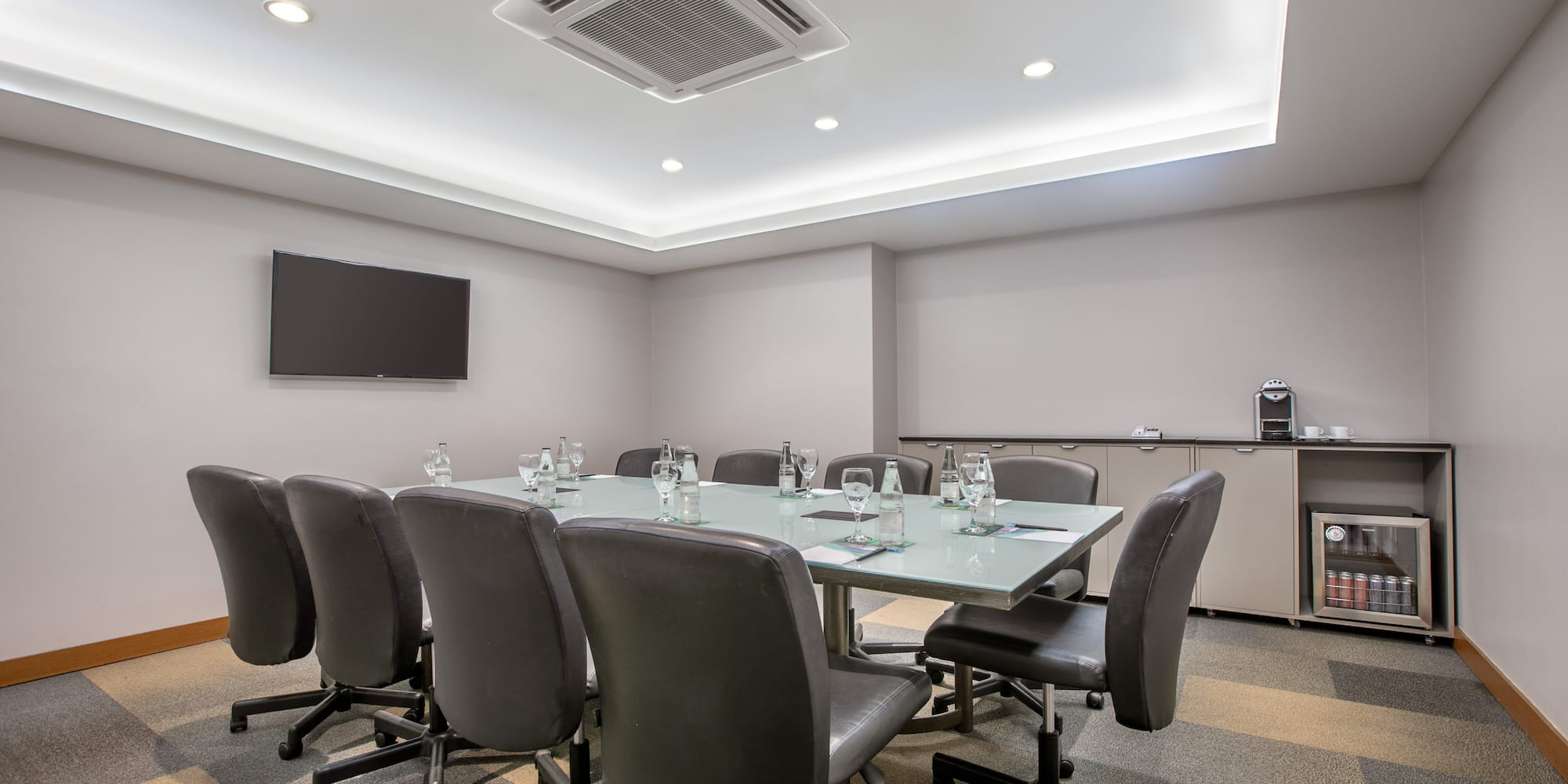 a conference room with a table and chairs