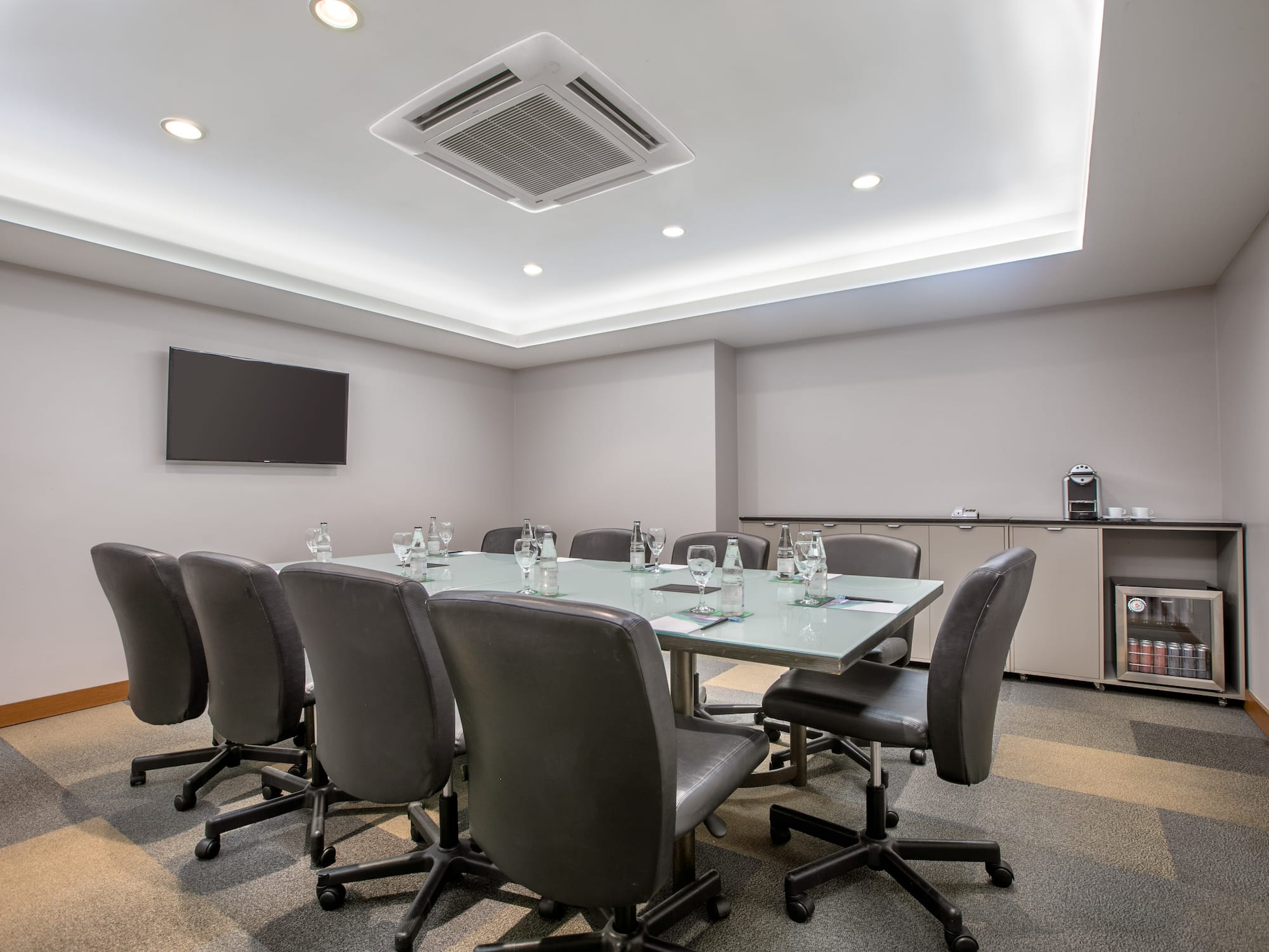 a conference room with a table and chairs