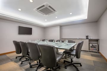 a conference room with a table and chairs
