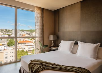 a bed with a window and a view of a city