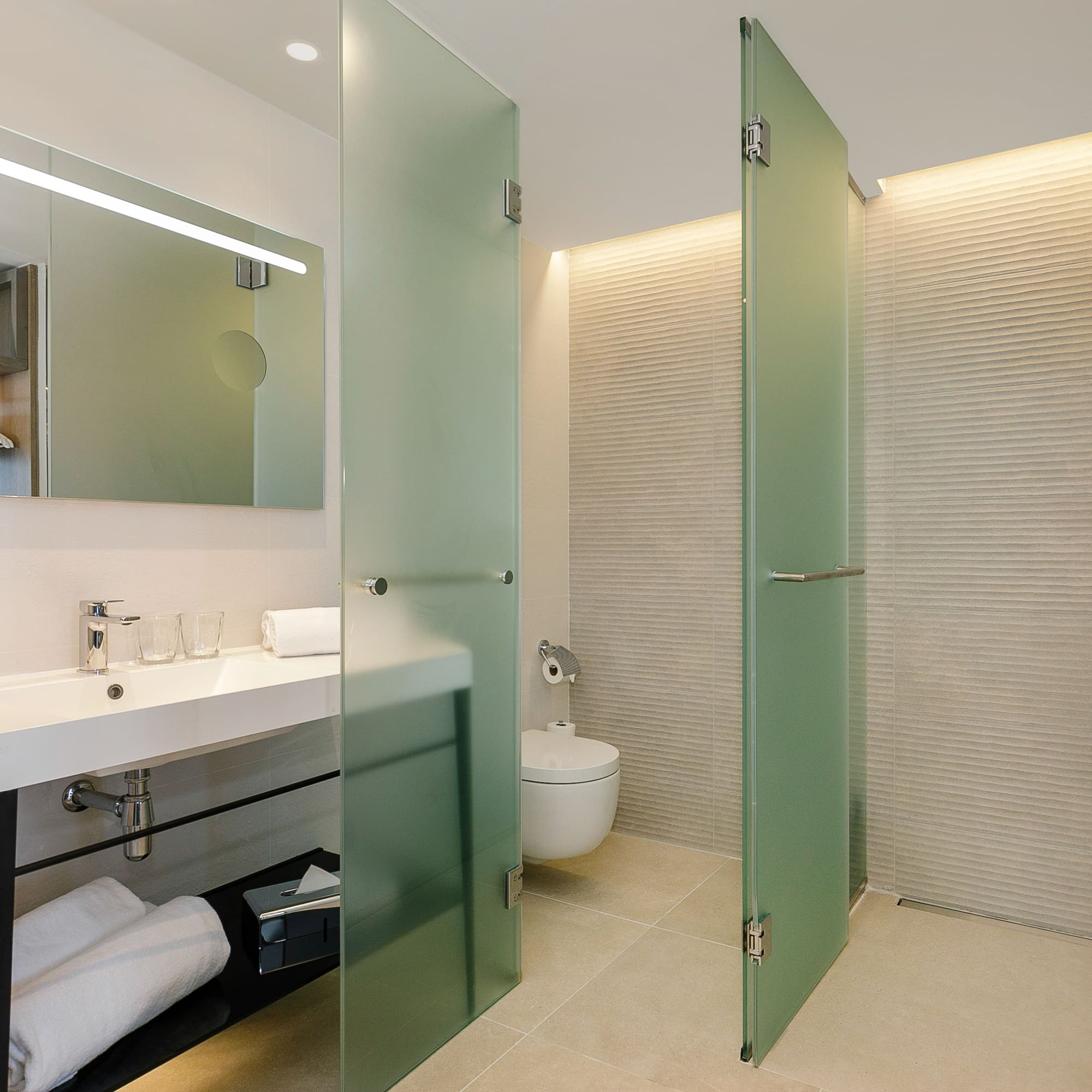 a bathroom with glass doors