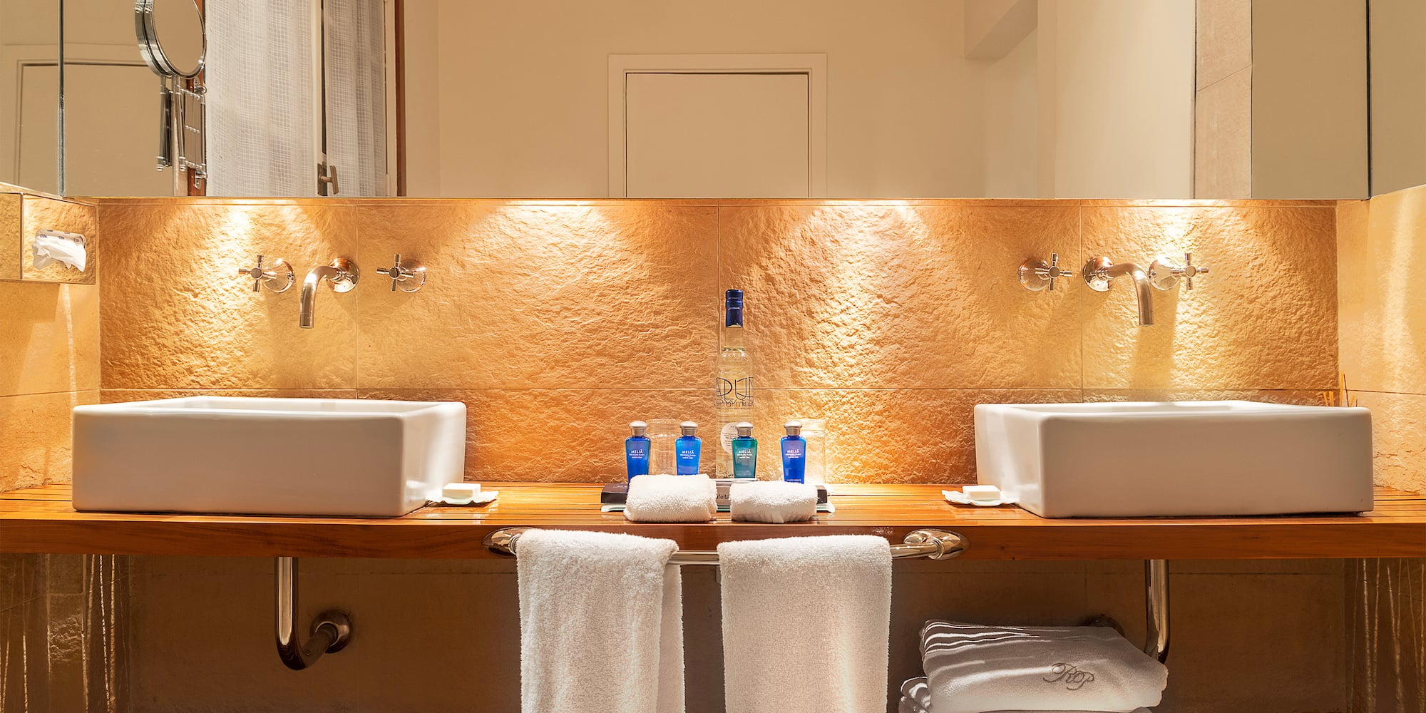 a bathroom with sinks and towels