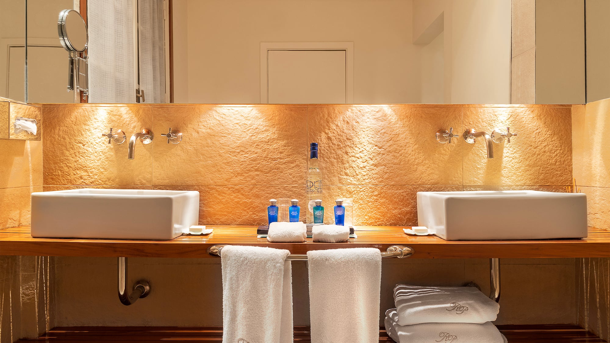 a bathroom with sinks and towels