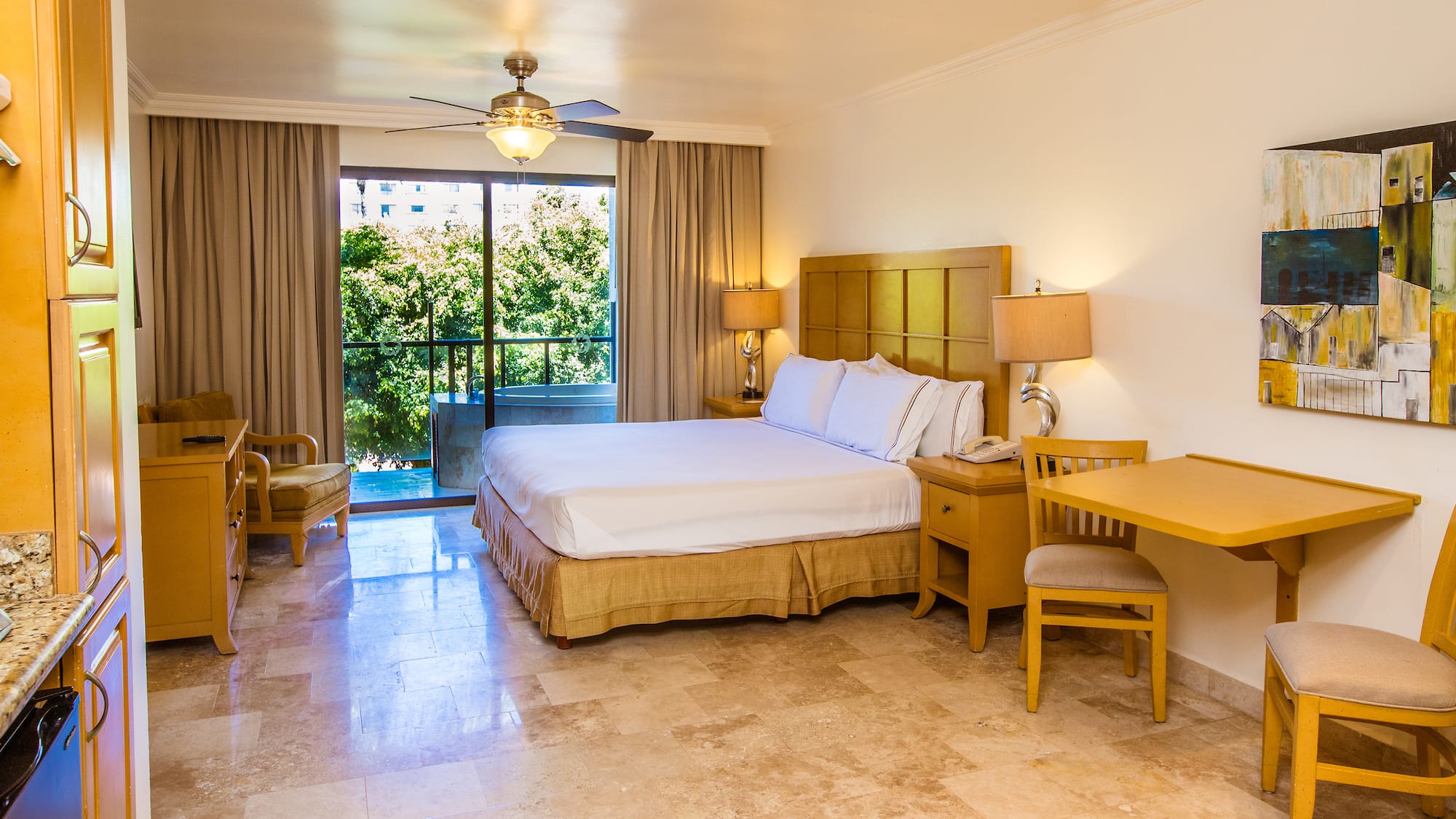 a bedroom with a bed and a table and chairs