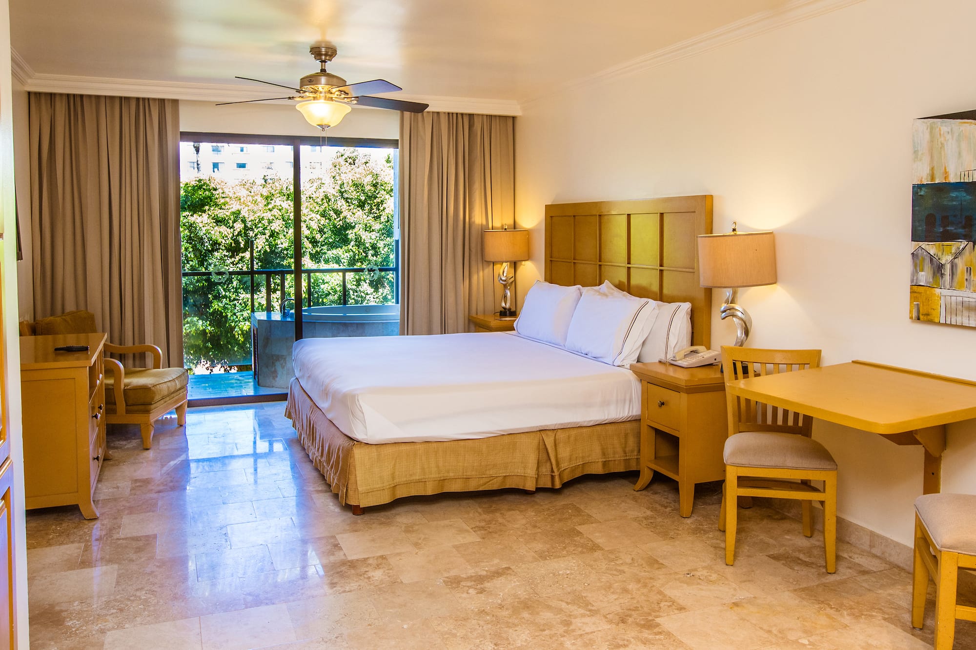 a bedroom with a bed and a table and chairs