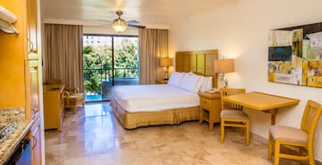 a bedroom with a bed and a table and chairs