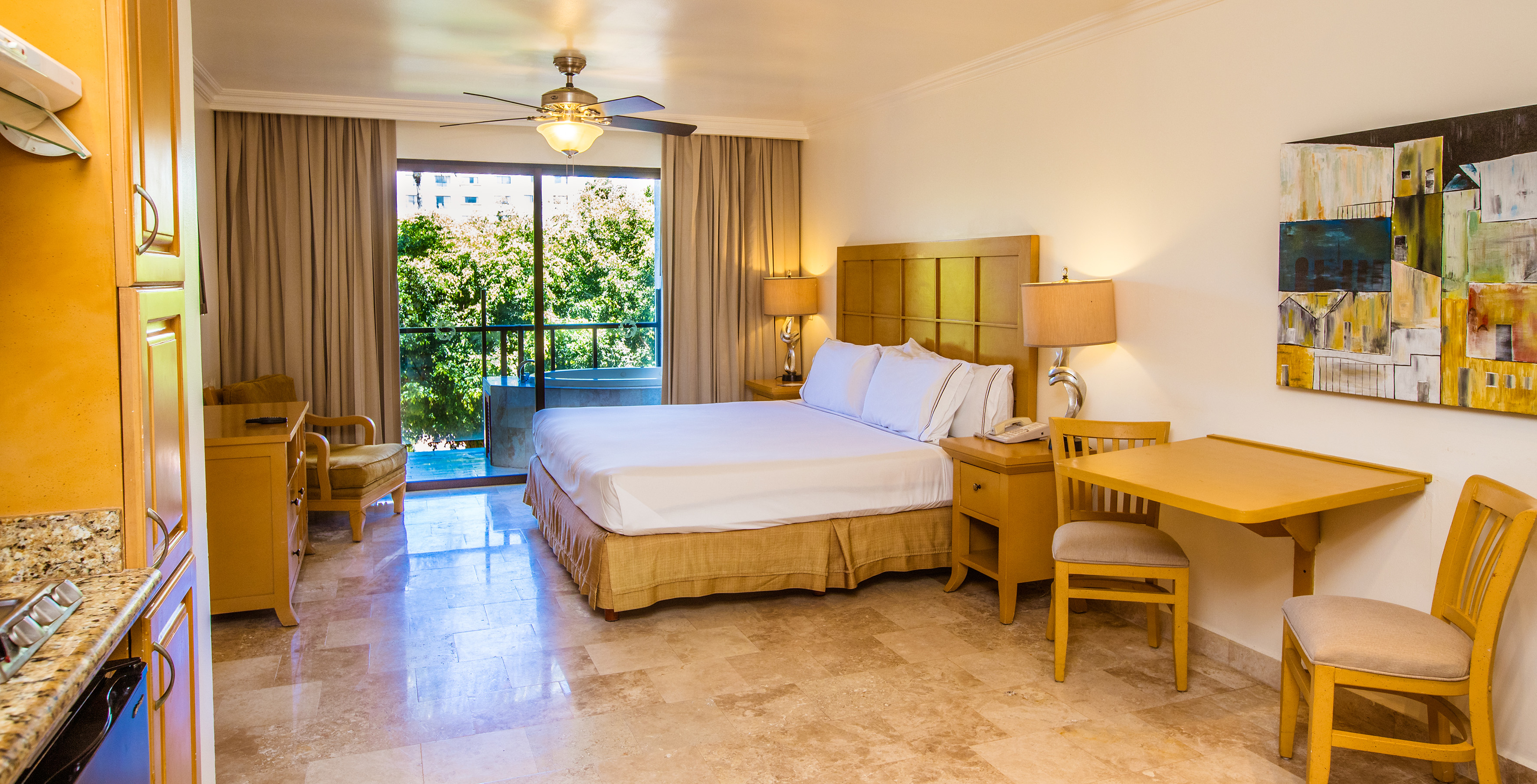 a bedroom with a bed and a table and chairs