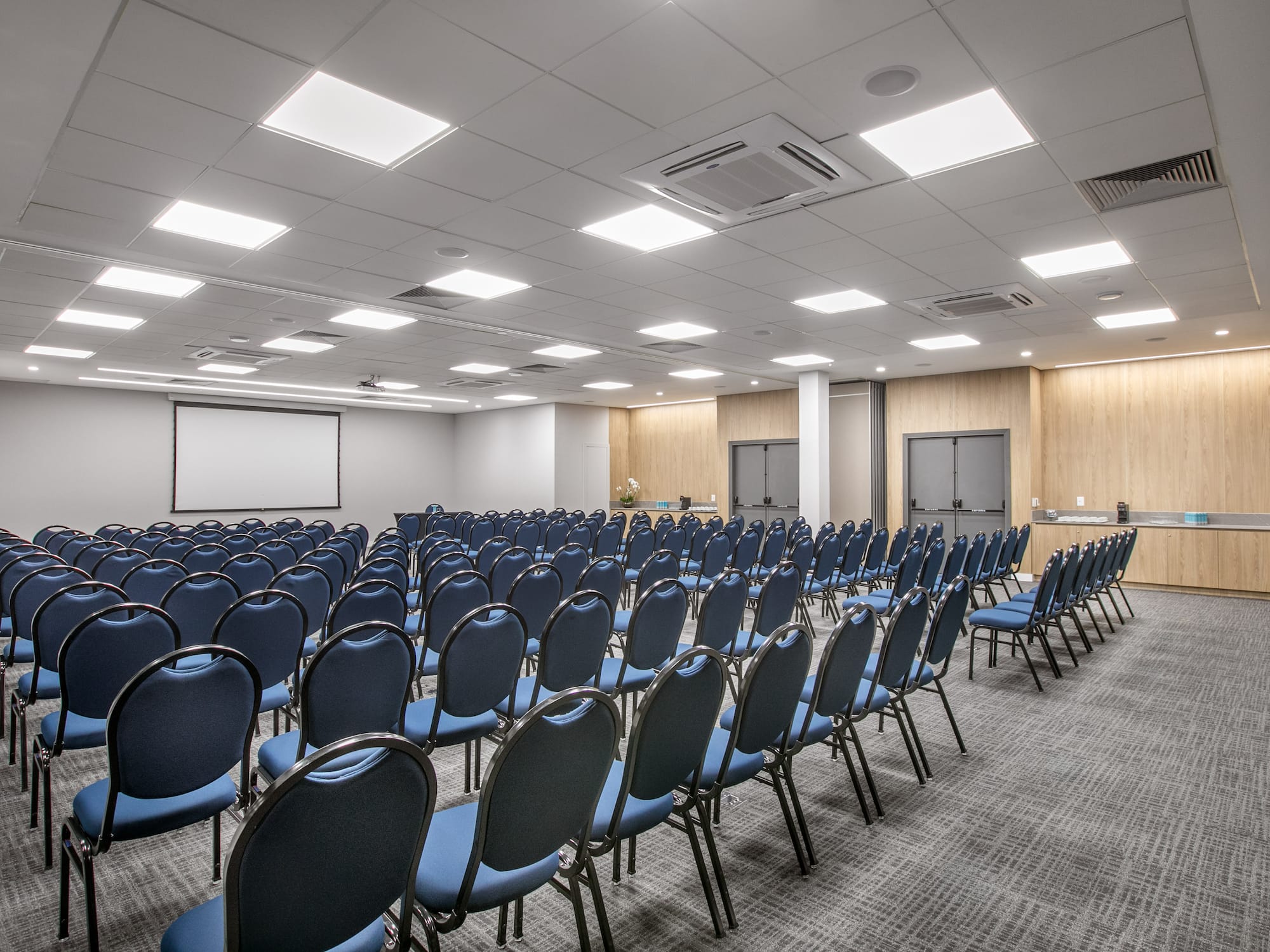 a room with rows of blue chairs