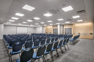 a room with rows of blue chairs