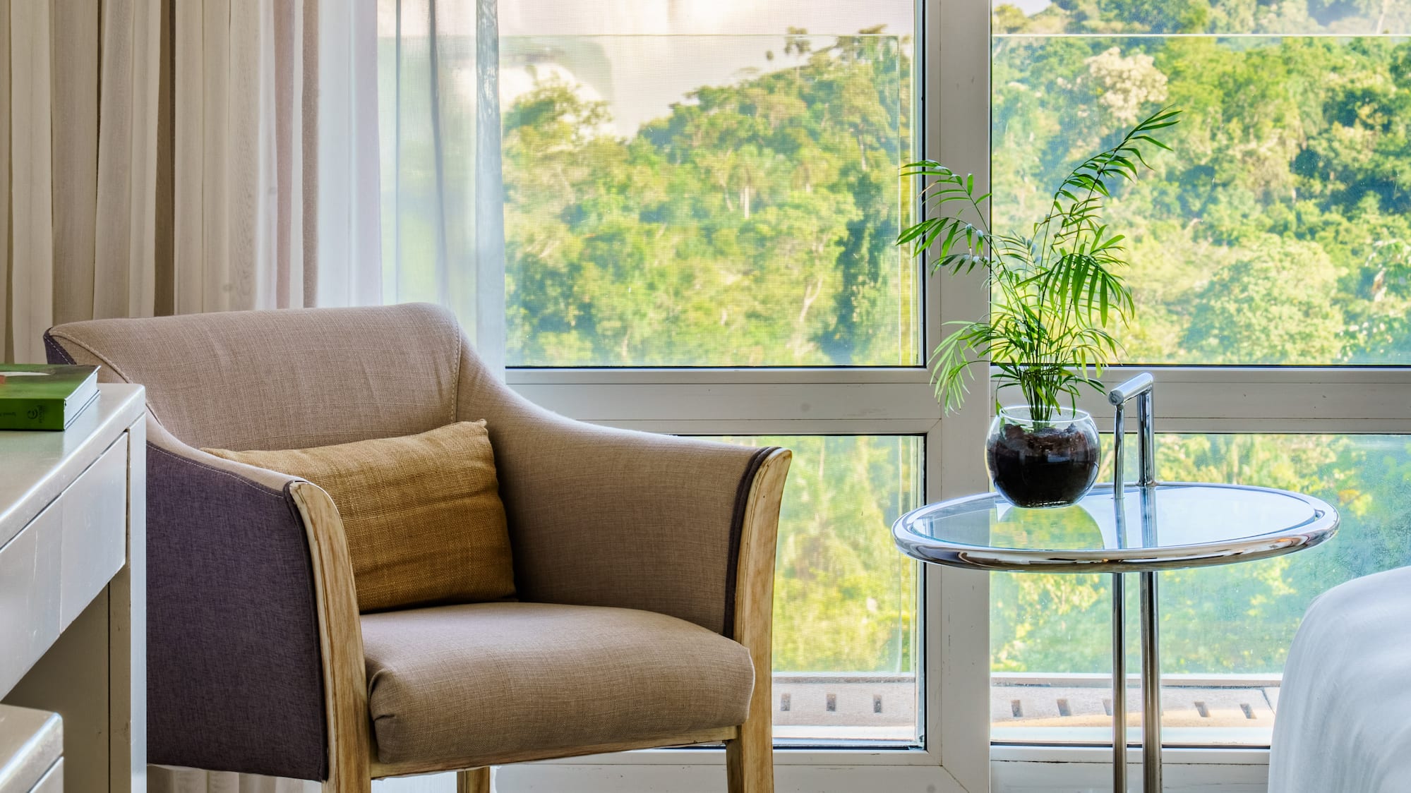 a room with a window and a chair and a table